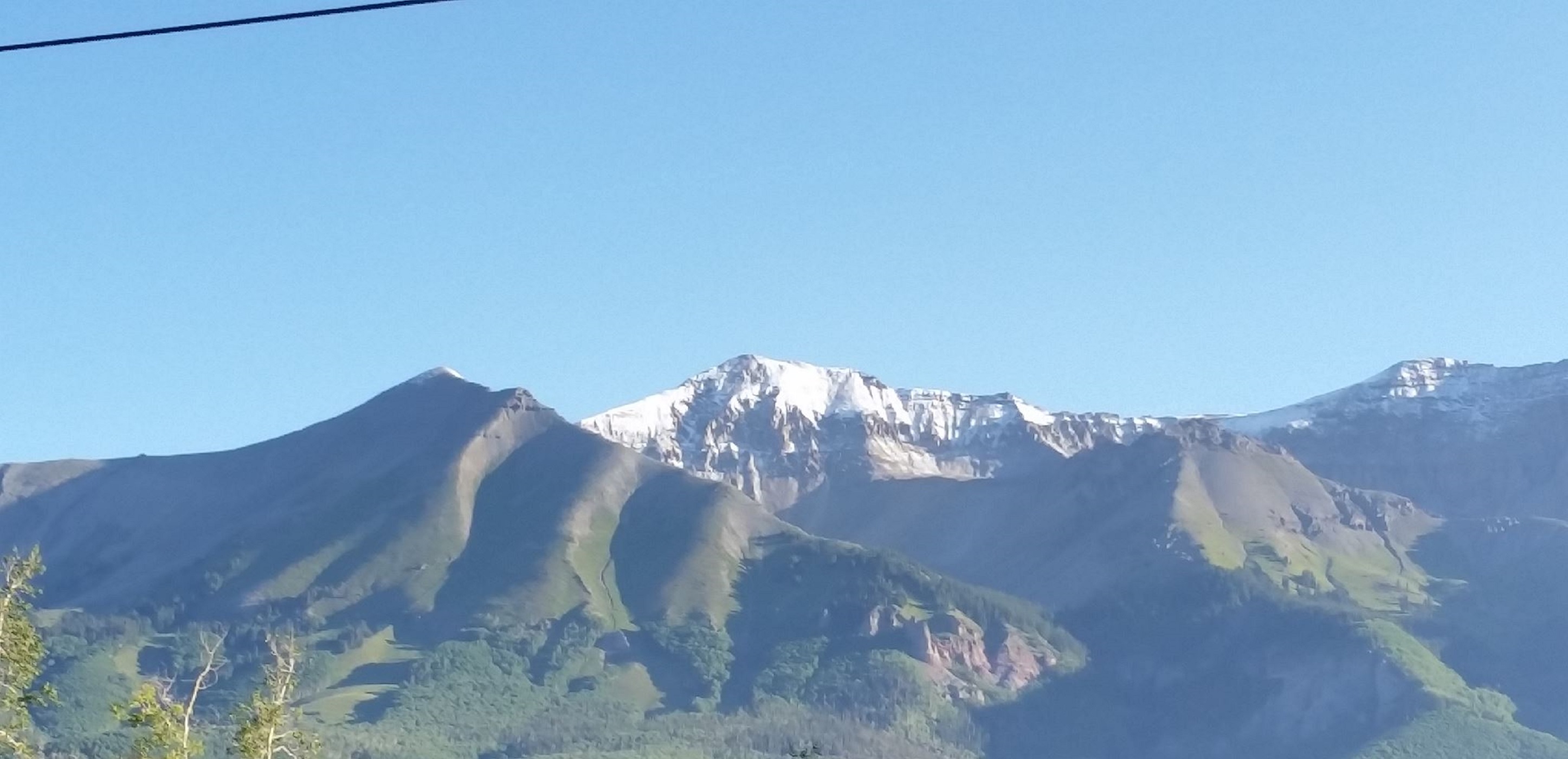 Snow-capped mountains beneath a blue sky